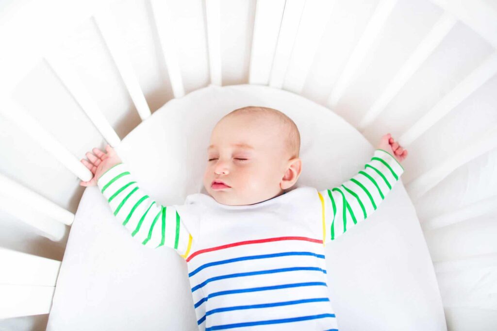 baby sleeping in bassinet